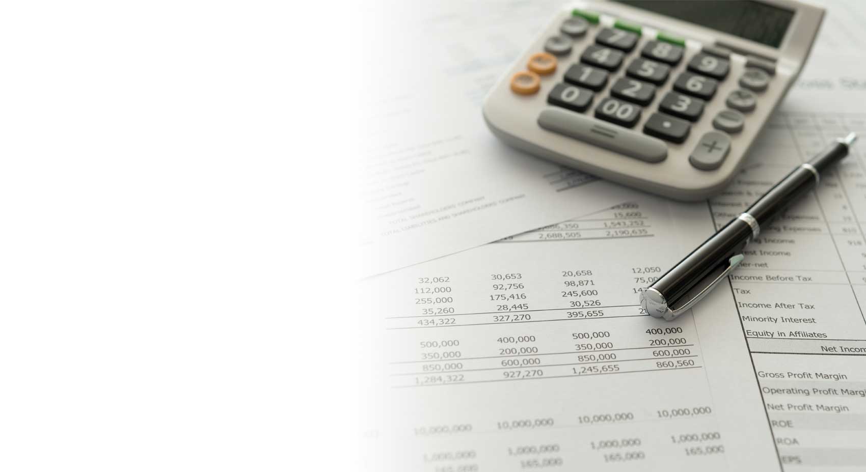 accounting reports with a calculator and pen